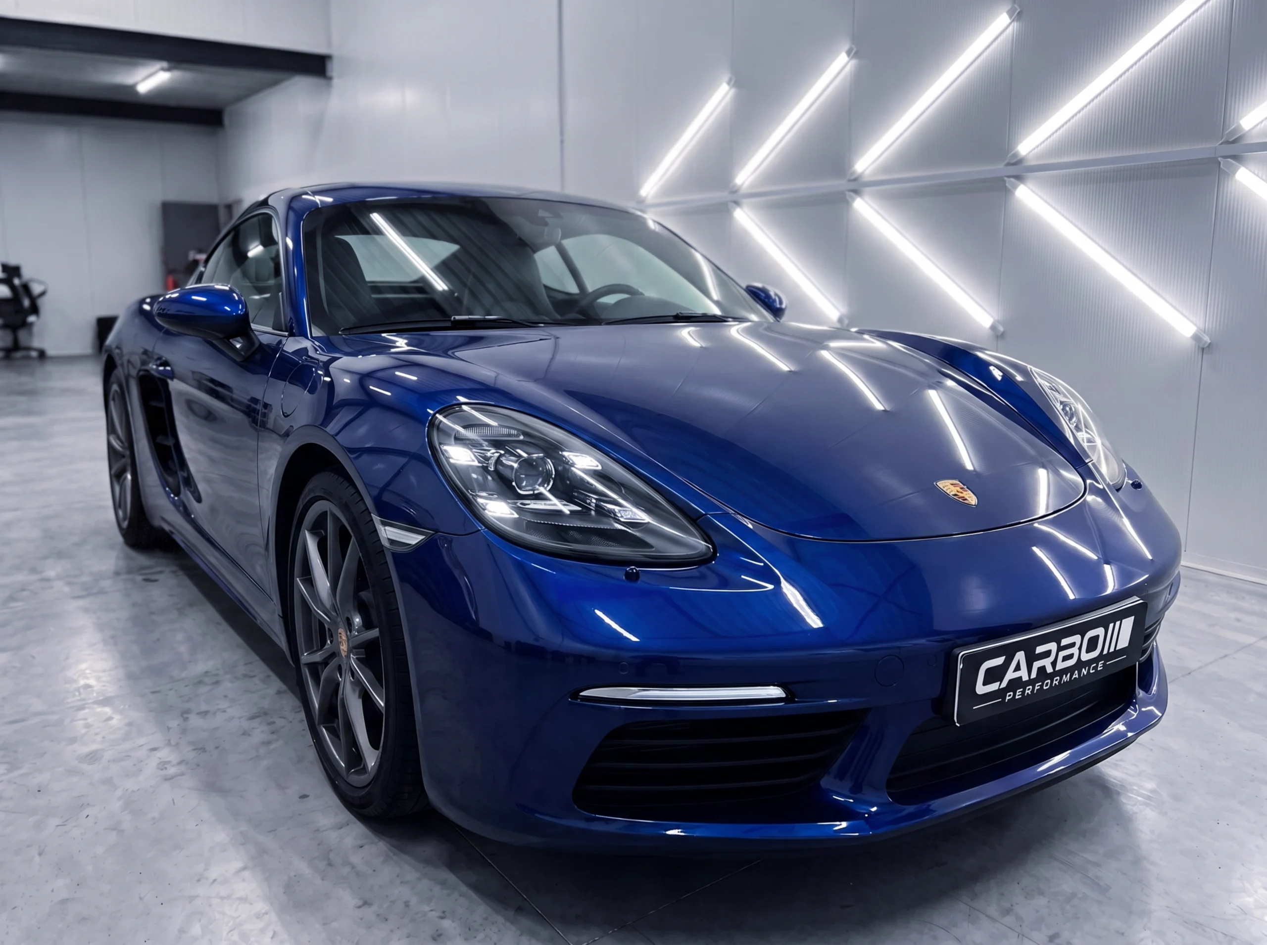 Carbo-Portofilo 24 Donkerblauwe Porsche 718 Cayman na een intensieve Full Detailing behandeling met spiegelglans afwerking in de studio